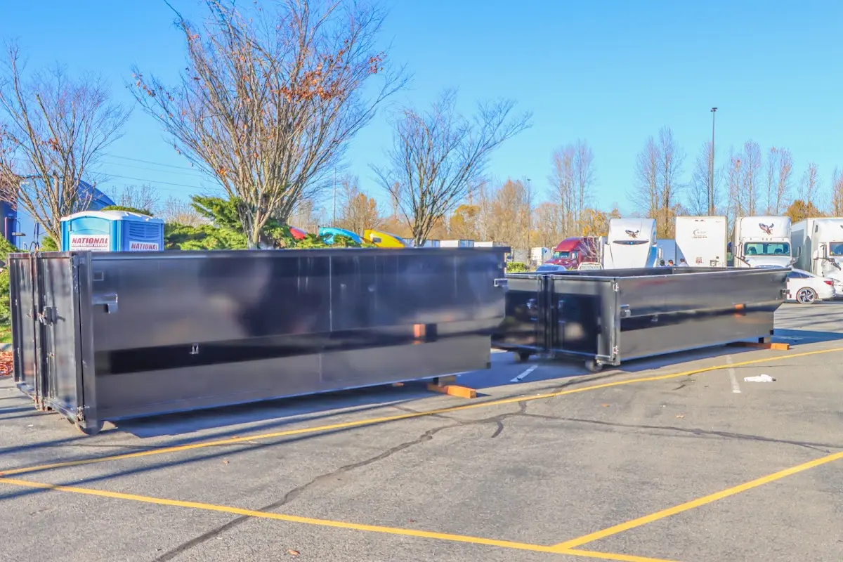 Professional dumpster rental service with roll-off container on residential driveway in Garden Home-Whitford